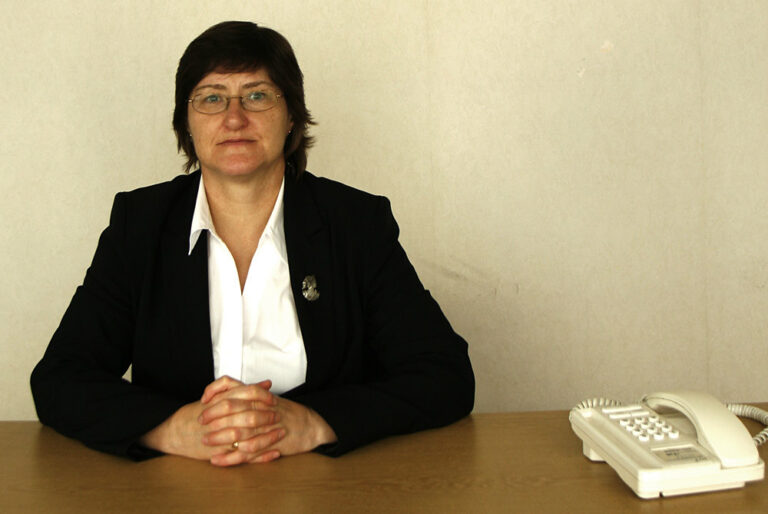 A composed professional sitting at a desk, illustrating the quiet self-doubt behind imposter syndrome