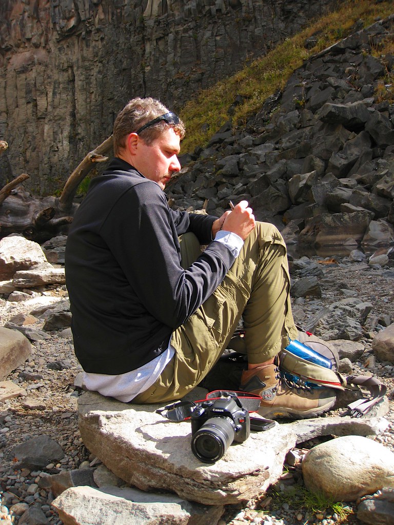Man writing thoughtfully in a journal outdoors, practicing real gratitude rather than toxic positivity