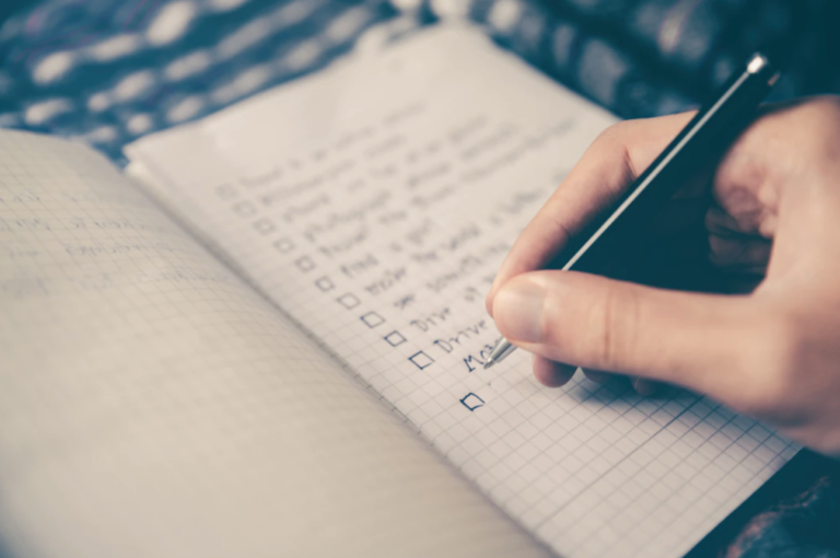 A handwritten checklist in a notebook, illustrating the Zeigarnik effect of unfinished tasks